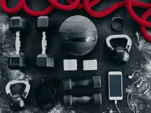Dumbbells, kettlebells, and resistance bands laid out flat