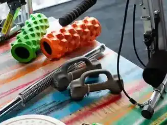 Foam rollers and recovery tools on a gym bench