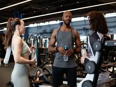 Fitness coach consulting with clients on the gym floor
